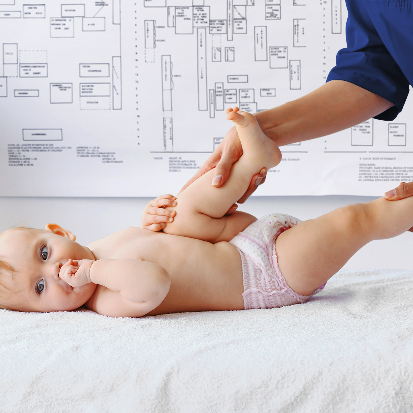 Massage therapist working with cute baby in medical center